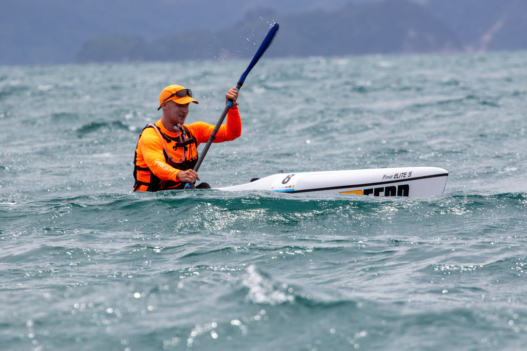 Man paddling on a calm day wearing Sharkskin Performance Wear